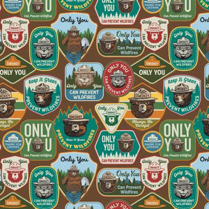 A collection of park signs featuring the iconic Smokey Bear cover a wood-brown background is the main fabric for this collection. Each bundle includes 6 fat quarters. Greens, browns, beige and black are main colors for this pack. From the Smokey the Bear Collection for Riley Blake. 100% Cotton, 44/5"