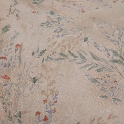 This lovely fabric is a cotton shirting which has an amazing soft hand. This fabric is a beige floral with muted green leaves, light periwinkle flowers and pops of burnt orange. The background of this fabric is a light brown beige.